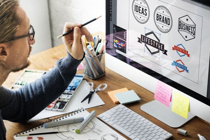 Graphic designer working on brand layouts